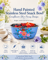 Hand painted stainless steel snack bowl with cornflower blue pansy design on a table with flowers and fruit.