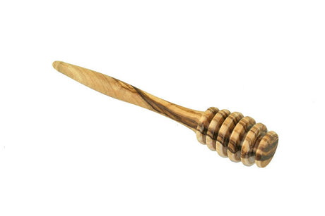 Wooden honey dipper on a white background