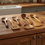 Set of wooden kitchen utensils including spoons and spatulas on a white background