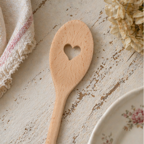 wooden spoons with heart designs on a rustic kitchen setting.