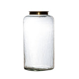 Clear glass jar with a gold lid on a white background
