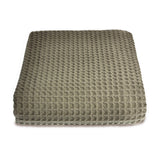 Textured green throw on white background