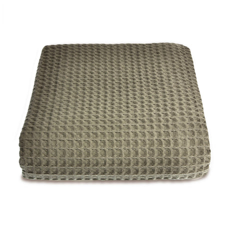 Textured green throw on white background