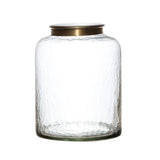 Clear glass jar with a gold lid on a white background