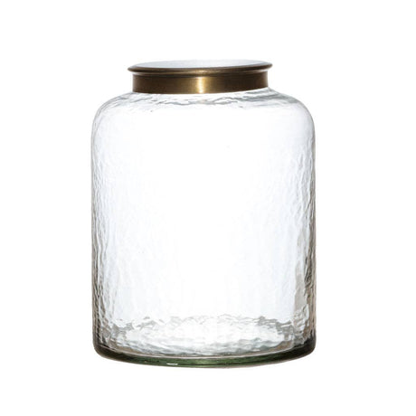 Clear glass jar with a gold lid on a white background