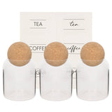 Set of three glass jars with cork lids labeled 'Tea', 'Coffee', and 'Sugar' on a white background.