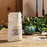 Bag of 'Shell on Earth' coffee on a wooden table with decorative elements