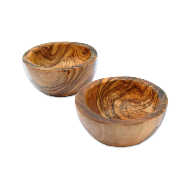 Two wooden egg cups with a wavy pattern on a white background