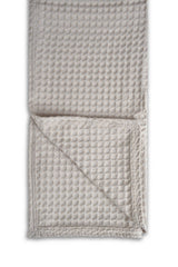 Woven textured blanket on a white background
