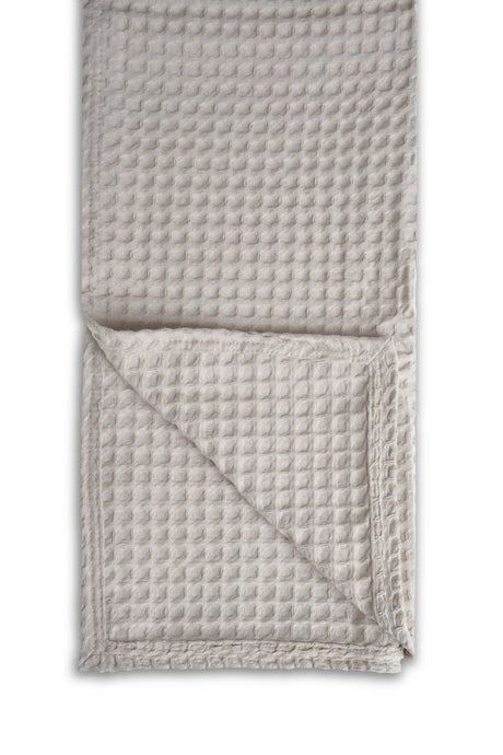 Woven textured blanket on a white background