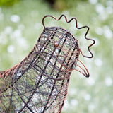 Decorative wire rooster sculpture on a grassy lawn
