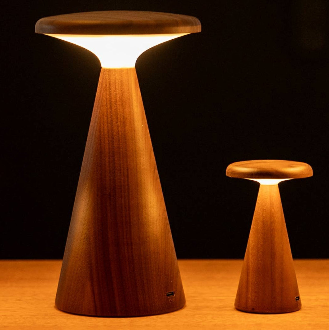 Set of four wooden lights on a wooden surface.