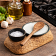 a kitchen scene with a wooden salt pot and spoon rest