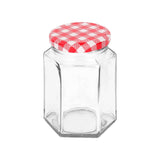 Clear glass jar with a red and white checkered lid on a white background