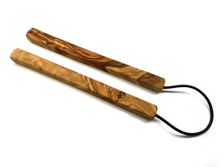 wooden trivet with black cords on a white background