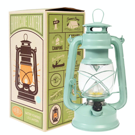 Turquoise lantern with packaging featuring illustrations of camping scenes.