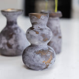 Three textured vases on a white surface