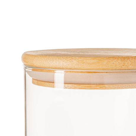 Glass container with a wooden lid on a white background