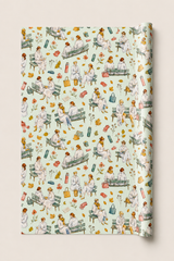 A roll of wrapping paper featuring a vintage-style watercolor pattern of women in white sitting on park benches with flowers, leaves, and medical-themed items, shown against a light beige background.