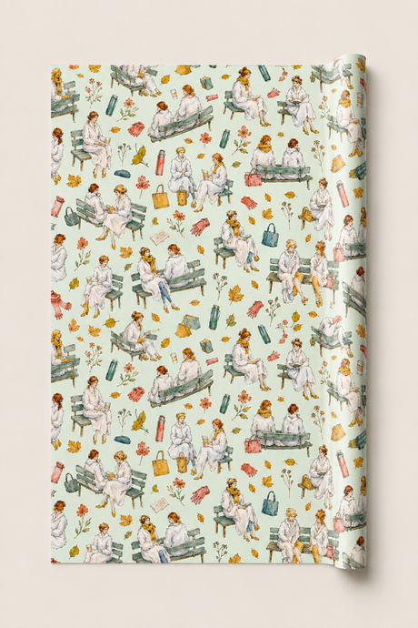 A roll of wrapping paper featuring a vintage-style watercolor pattern of women in white sitting on park benches with flowers, leaves, and medical-themed items, shown against a light beige background.