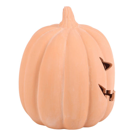A decorative terracotta orange pumpkin-shaped decoration with a ribbed texture and carved triangular eye and mouth cutouts, shown on a plain white background.