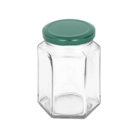 Clear hexagonal glass jar with a green lid on a white background
