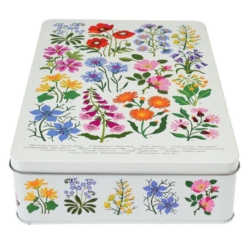 A rectangle metal tin decorated with colourful wildflower illustrations on a white background, photographed on a clean white studio background.