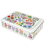 A rectangular metal tin with a white background decorated with a colorful wildflower pattern on the lid and sides, shown on a plain white background.