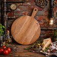 Wooden pizza peel on a rustic kitchen counter with ingredients and industrial decor.
