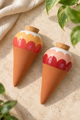 Bring blush pink, coral red and ochre into your houseplant collection. These Ana Rose terracotta watering spikes combine scalloped ceramic tops with a practical slow-release watering function