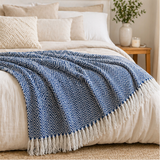 Blue herringbone blanket with white fringe displayed in various settings.