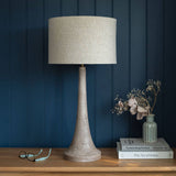 Backwell mango wood table lamp with a pale sandblasted base and cream linen drum shade
