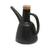 Black ceramic oil dispenser with a cork lid on a white background