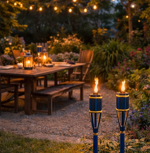 outdoor settings with blue torches illuminating  garden dining area.