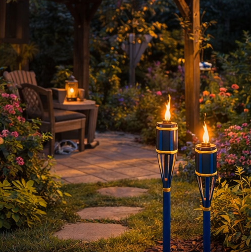 outdoor settings with blue torches illuminating garden  seating area.