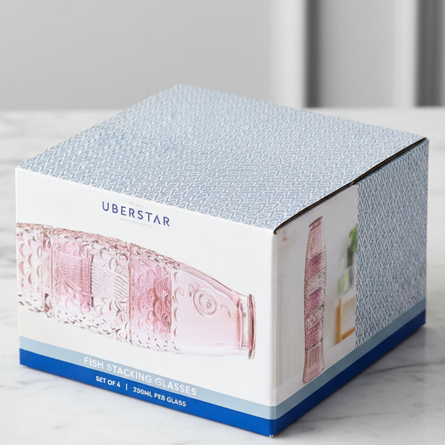 Box of Uberstar pink drinking glasses on a kitchen side