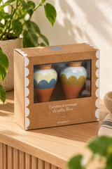 Set of two ceramic watering spikes for potted plants. Ana Blue includes complementary scalloped designs in blue, pale cream and olive, with white tops, terracotta-coloured tapered points and cork stoppers. Presented together in a windowed cardboard box