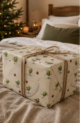 Scarf-wearing Brussels sprouts skate, race and tumble across the ice in this funny illustrated Christmas wrapping paper, with cranberries, skating poles and looping skate marks on warm ivory.