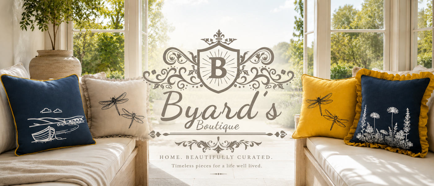 Decorative Linen pillows on a couch with Byard's Boutique logo in the centre. 