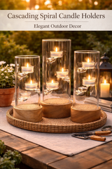 Cascading spiral candle holders on a wooden table with candles lit, set against an outdoor background.