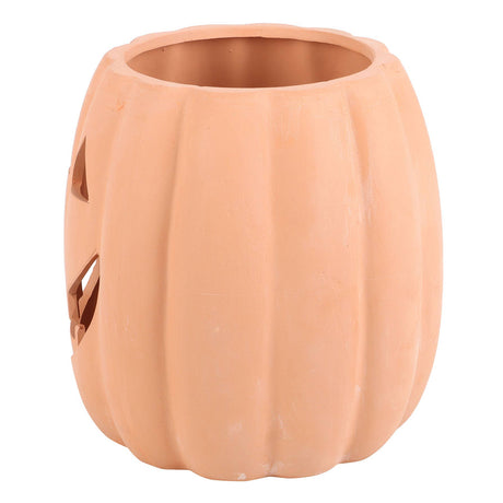 Ceramic pumpkin with jack-o'-lantern face on a white background