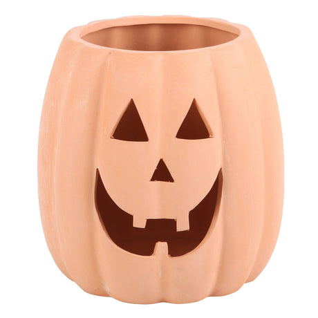 Ceramic pumpkin with jack-o'-lantern face on a white background
