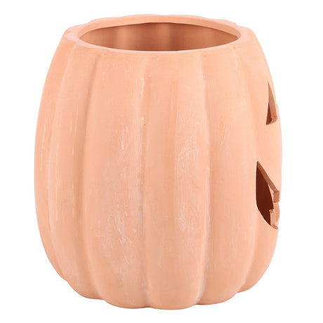 Ceramic pumpkin with jack-o'-lantern face white background