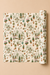 A roll of Christmas wrapping paper with a detailed garden and greenhouse pattern, partially unrolled to show the repeating design on a solid beige background.