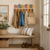 Entryway with wooden bench, coat rack, and shoes on a neutral background