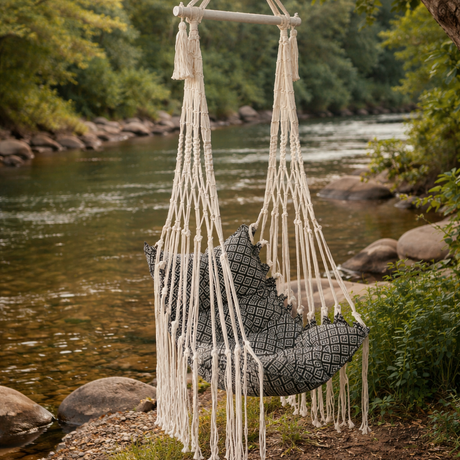 Macrame chair swing hanging by a tree by a river