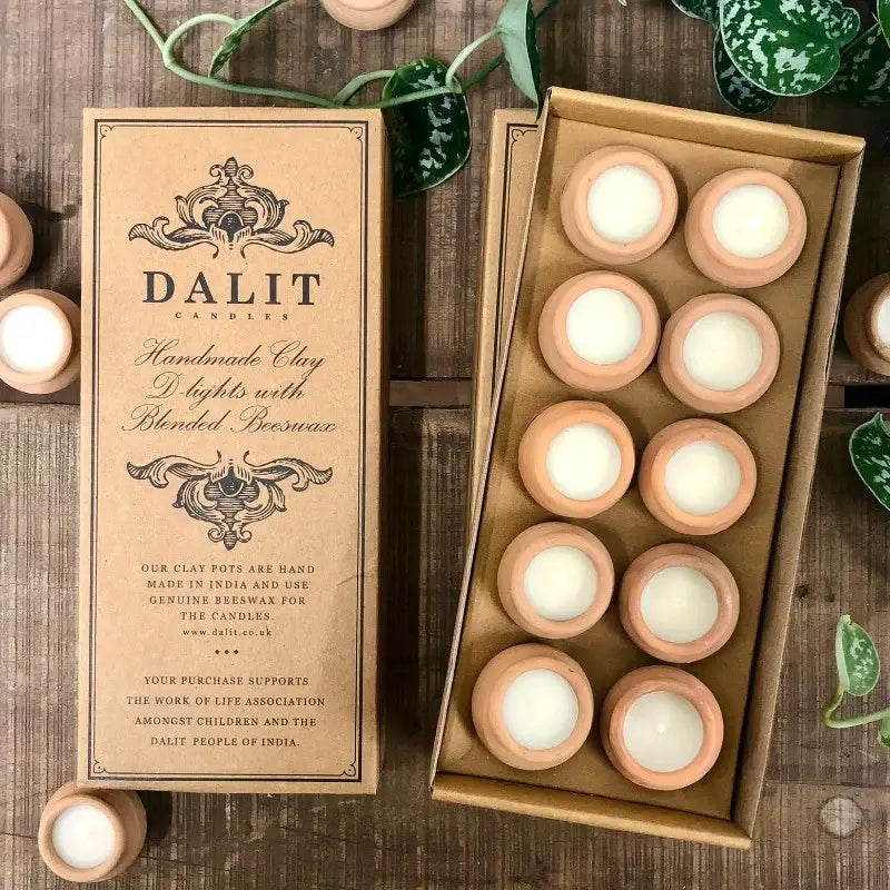 Dalit candles packaging with candles inside a box on a wooden surface