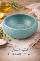 Handcrafted ceramic bowl on a wooden surface with herbs and oil.