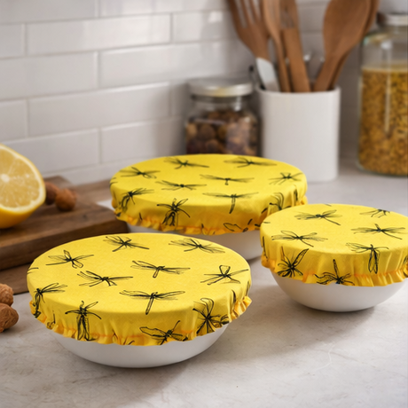 Yellow covers with black patterns on bowls in various settings