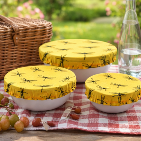 Yellow covers with black patterns on bowls in various settings